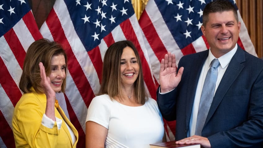 Rep. Brad Finstad, right, with Nancy Pelosi, left, in swearing-in photo