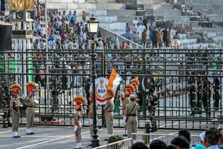 Indian and Pakistani troops take part in a border ceremony at the Attari-Wagah frontier in