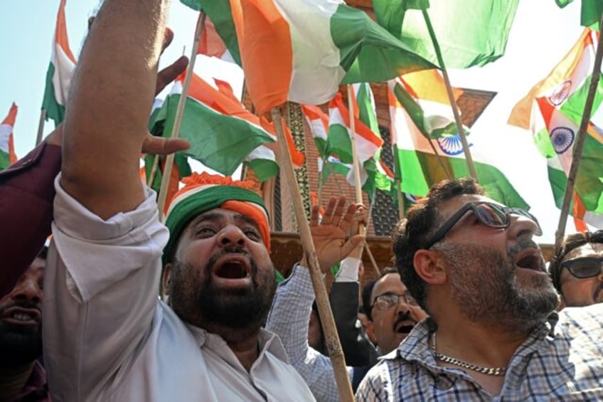 Supporters of India's Bharatiya Janata Party shout slogans and wave country's national fla