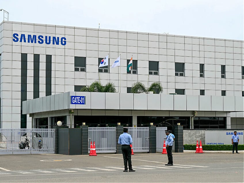 Security personnel stand guard at Samsung India's plant in Sriperumbudur, near Chennai on