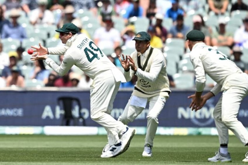 Australia's Steve Smith takes a catch to dismiss India's Rishabh Pant