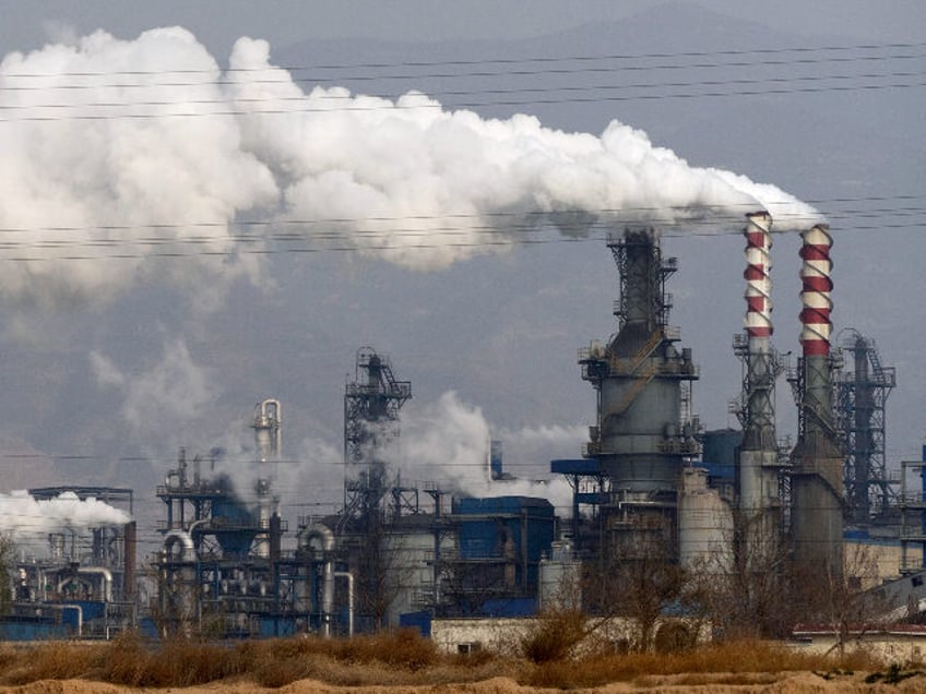 FILE - In this Nov. 28, 2019, file photo, smoke and steam rise from a coal processing plan