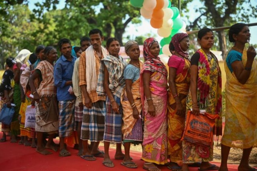People queue to vote in a village in Bastar district, one of the last strongholds of the N