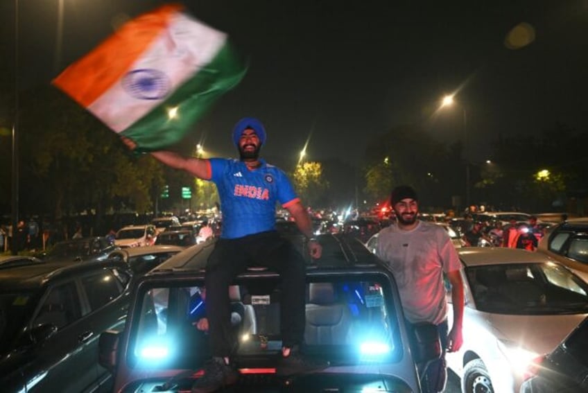 Cricket-crazy India erupted with midnight celebrations as fans in blue Indian shirts on ca