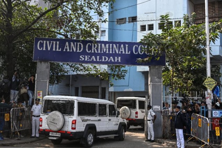 Police stand guard at a Kolkata court's entrance as the man accused of the rape and murder