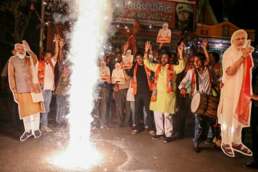 Supporters carrying portraits of Prime Minister Narendra Modi after he was sworn in for a