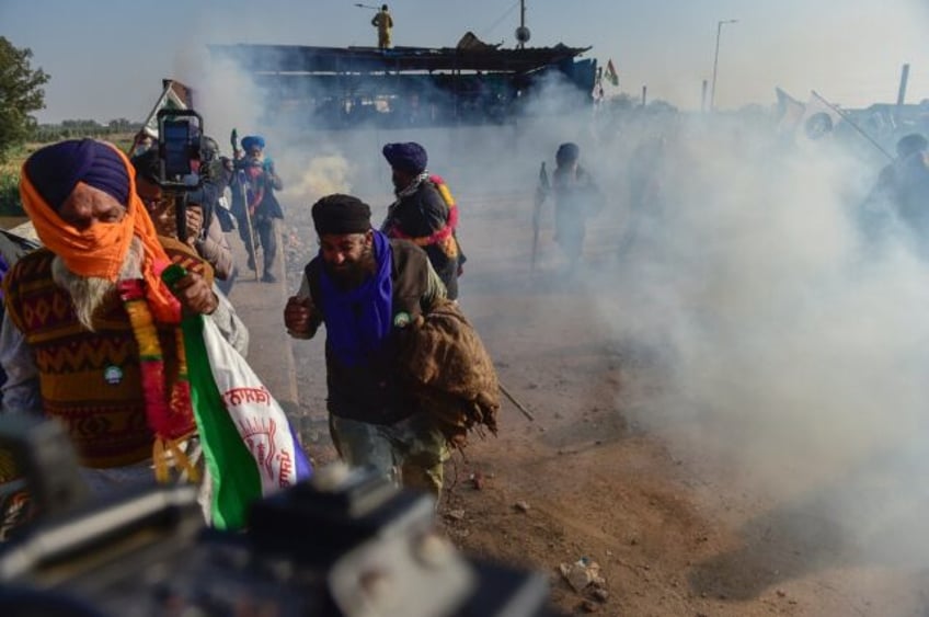 Indian police fire tear gas at protesting farmers attempting to march to the capital New D