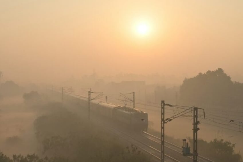 A train passes through heavy smog in India, where authorities have ordered an investigatio