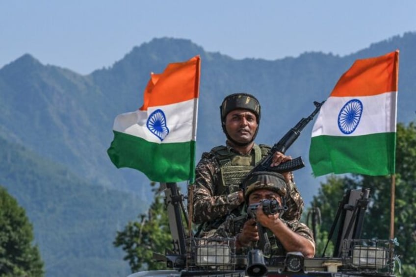 Indian troops take part in a rally during ahead of the country's independence day in Srini