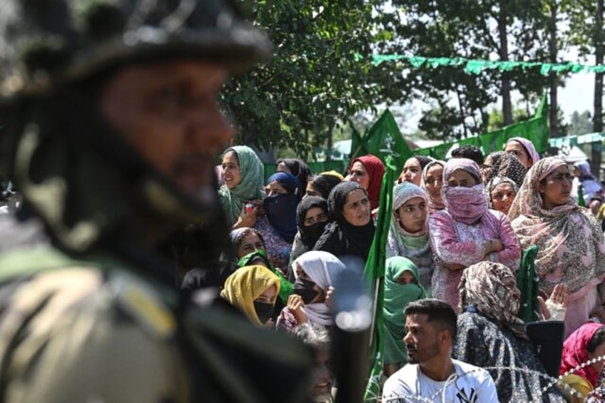 An Indian soldier stands guard during an election campaign rally ahead of assembly electio