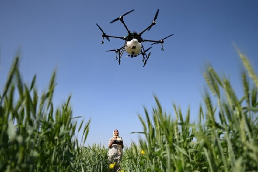 Sharmila Yadav, a remote pilot trained under the "Drone Sister" programme, operates a dron