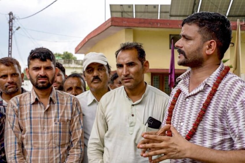 Hardline Hindu nationalist Rakesh Tomar (R) celebrated the departure of Muslims from Purol