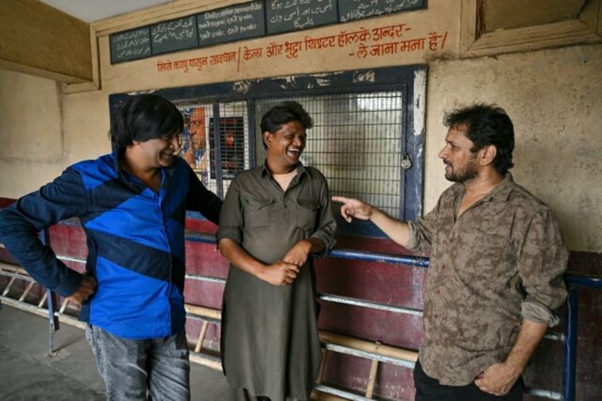 Filmmaker Shaikh Nasir (R) speaks with actor-directors Raju Sunny (C) and Asif Albela Jani