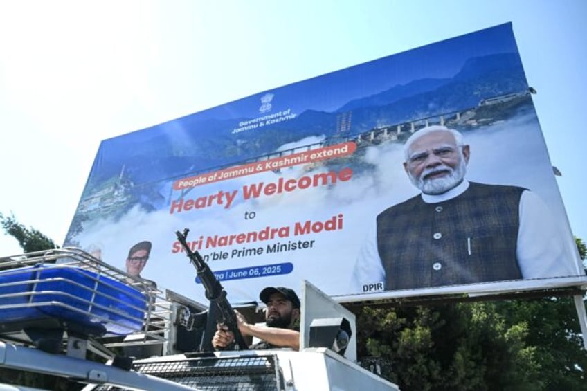 An Indian security officer keeps watch outside the Srinagar railway station ahead of the i
