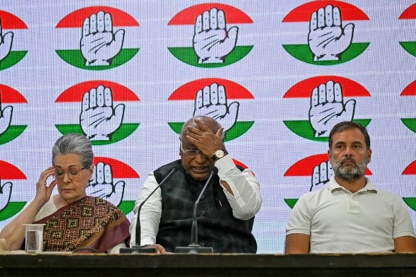 India's Congress party president Mallikarjun Kharge (C) addresses a press conference along