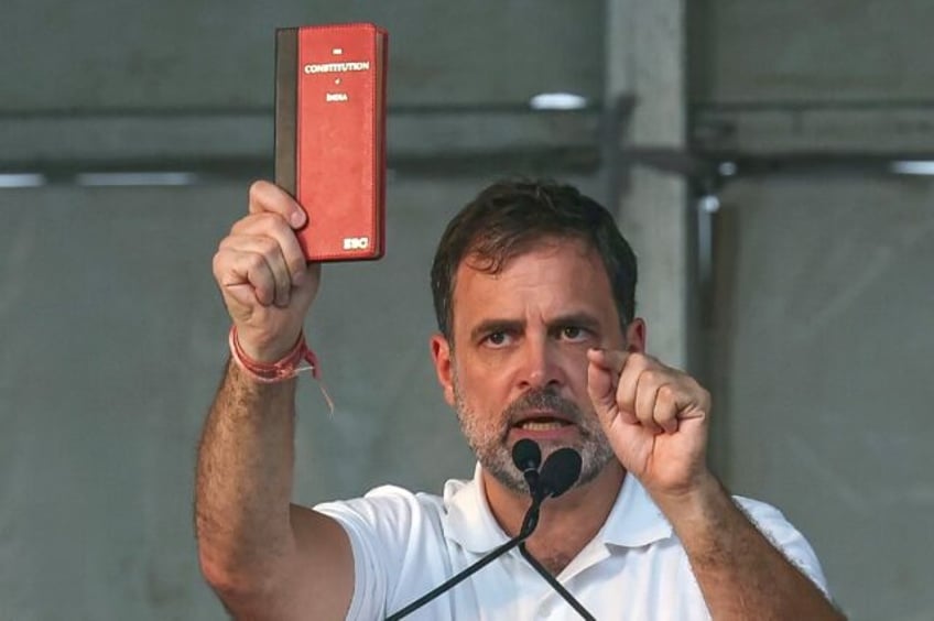 Rahul Gandhi, here holding a copy of the constitution, is taking on the formal post of lea