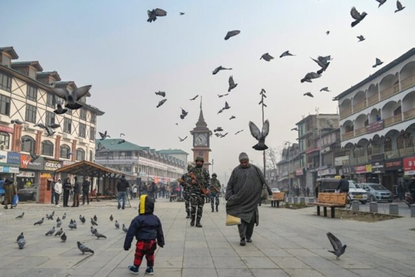 Indian paramilitary troopers patrol through Srinagar before a Supreme Court upheld the revocation of Indian-administered Kashmir's limited autonomy and ordered elections within a year