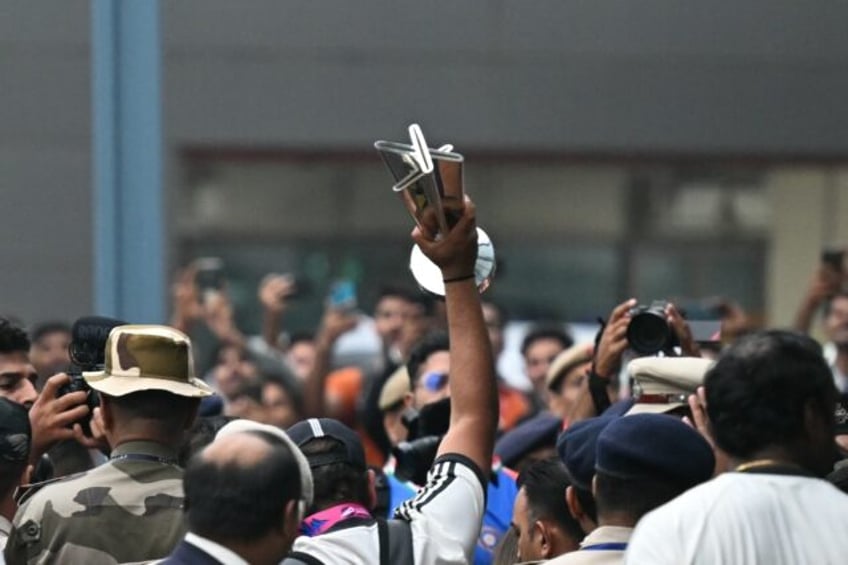 India captain Rohit Sharma lifts the T20 World Cup among crowds of fans as the team arrive