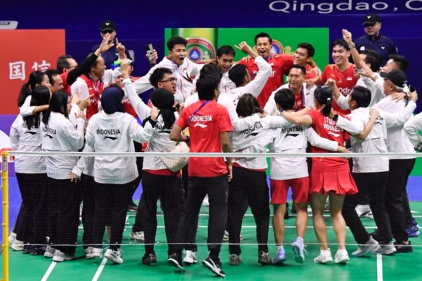 Members of Indonesia's team celebrate after winning the Badminton Asia Mixed Team Champion