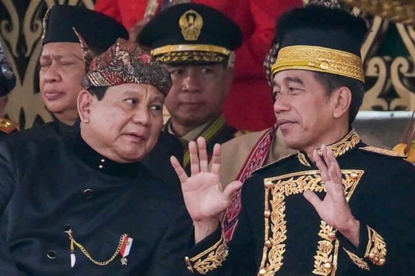 Indonesian President Joko Widodo (right) talks to President-elect Prabowo Subianto during