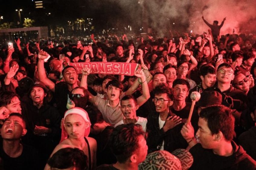 Indonesian football fans watched their team play Guinea on large screens across the countr