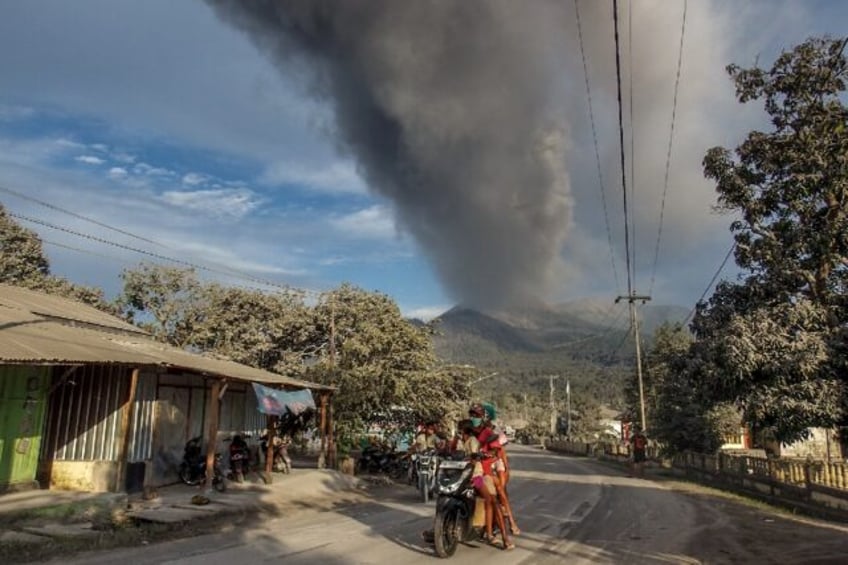 Villagers flee a volcano eruption in eastern Indonesia