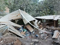 Indonesian rescuers dig through volcanic ash after eruption kills 9 and destroys buildings