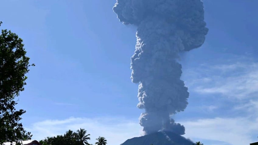 Mount Ibu spews volcanic materials into the air during an eruption