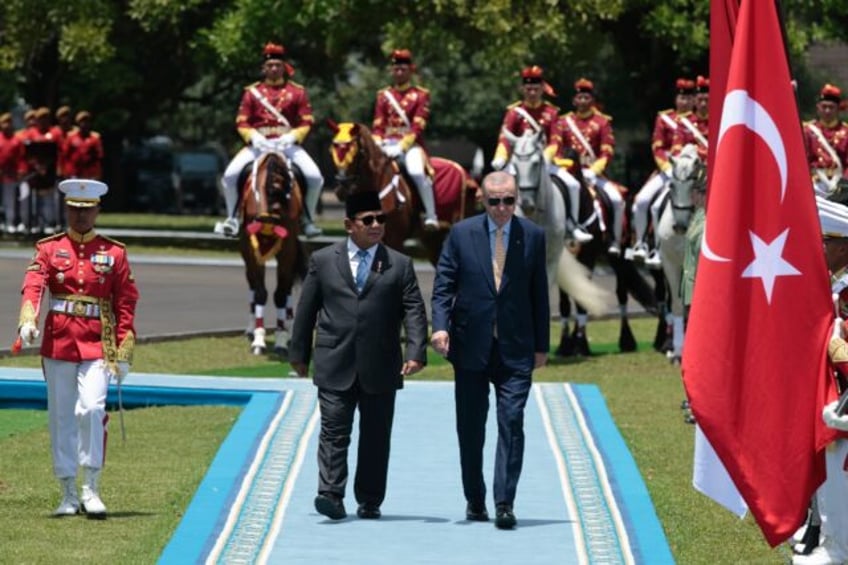Indonesia's President Prabowo Subianto and Turkey's President Recep Tayyip Erdogan inspect