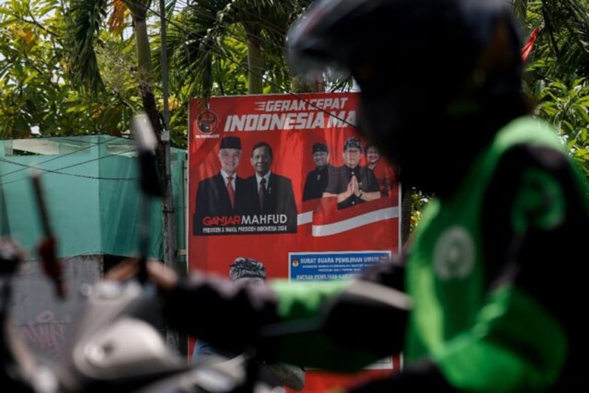 An election billboard of the Indonesian Democratic Party of Struggle (PDI-P) features candidates including Ganjar Pranowo (top-L)