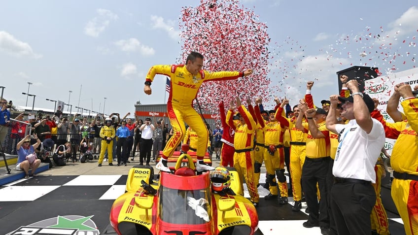 Alex Palou celebrates in victory lane with his team during the INDYCAR Series Race 2 at Iowa