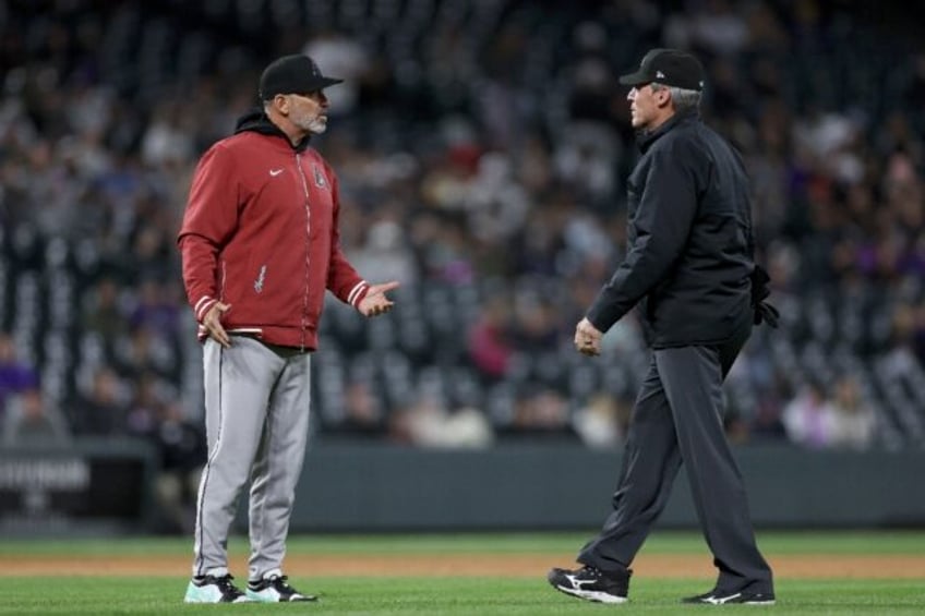 Familiar sight: Arizona manager Torey Lovullo confronts baseball umpire Angel Hernandez, w