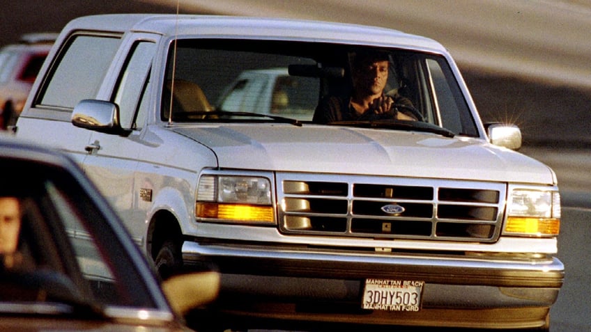 A Ford Bronco carrying OJ Simpson (hidden in rear seat) is reportedly driven by Simpson's former teammate Al Cowlings