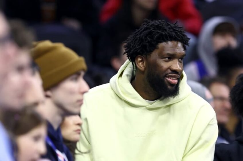 Reigning NBA MVP Joel Embiid of the Philadelphia 76ers watches from the sidelines after a