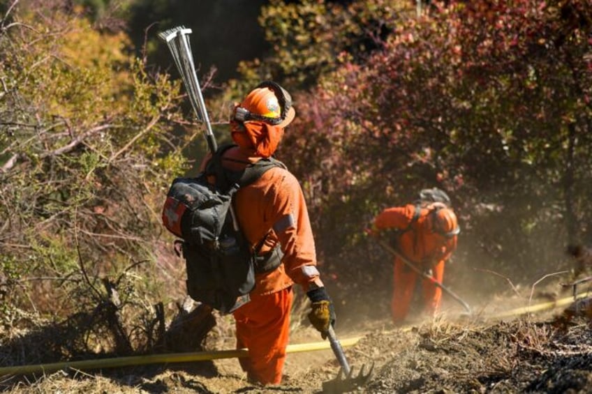 More than 900 inmates are working alongside firefighters in the battle to tame wildfires i