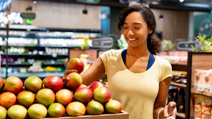 Woman shopping for mangos