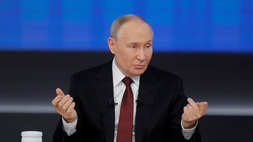 Russia's President Vladimir Putin gestures at his year-end press conference.