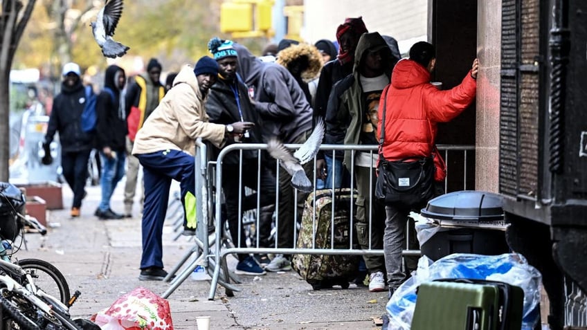 line up in front of the East Village re-intake, converted into a city-run shelter for newly arrived migrant families in New York City, United States on Dec. 4, 2023.