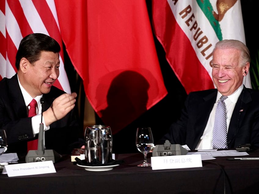 LOS ANGELES, CA - FEBRUARY 17: Chinese Vice President Xi Jinping (L) shows U.S. Vice President Joe Biden a chocolate-covered macadamia nut, given to him by Hawaii Gov. Neil Abercrombie, at the start of a meeting of Chinese and American governors, at Disney Hall February 16, 2012 in downtown Los Angeles, California. Xi, who is expected to become president of China in 2013, wrapped up the last day of his U.S. visit by urging closer ties between the two countries through increased trade. (Photo by Jay L. Clendenin-Pool/Getty Images)