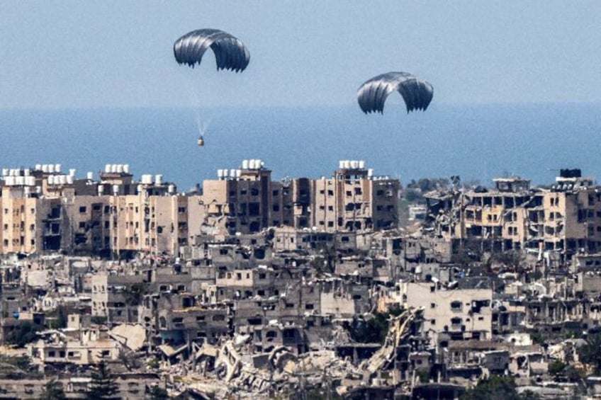 This picture taken from Israel's southern border with the Gaza Strip shows parachutes of h