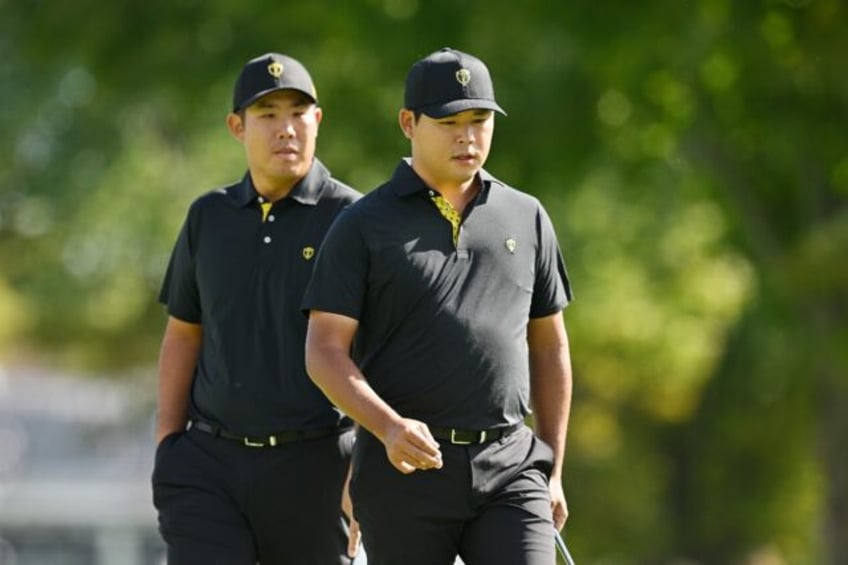 South Korea's Kim Si-woo, right, sank a 15-foot par putt to tie the 18th hole and give him