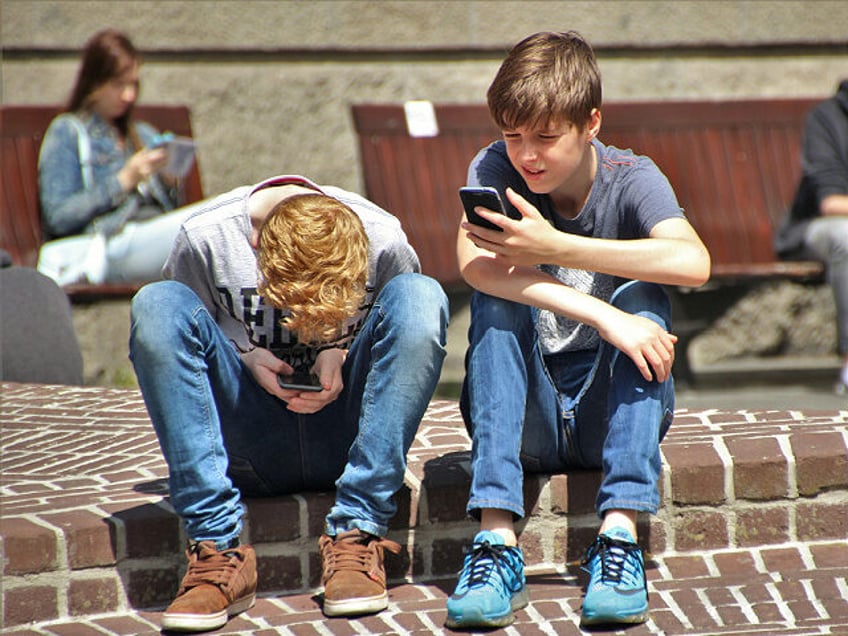 teens looking at social media on smart phones