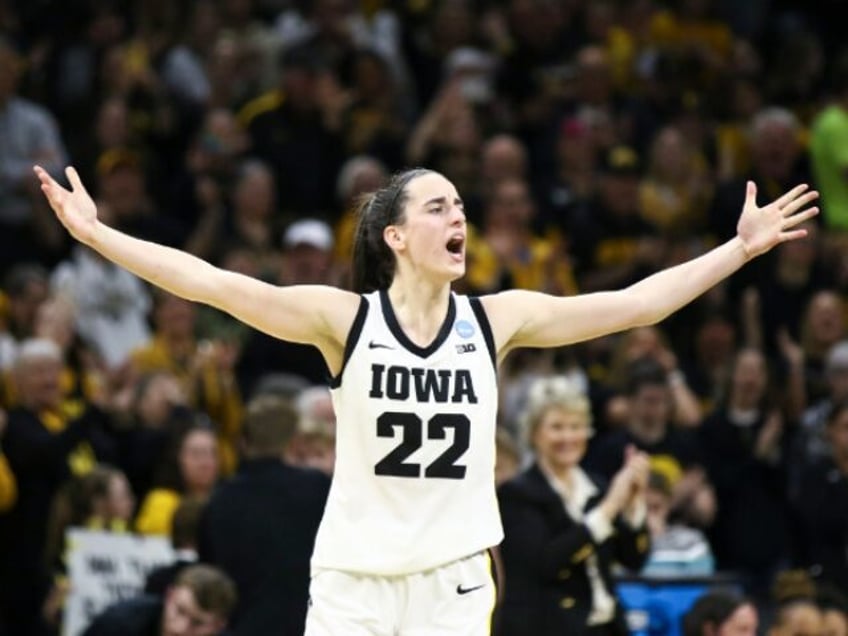 IOWA CITY, IOWA- MARCH 25: Guard Caitlin Clark #22 of the Iowa Hawkeyes celebrates after