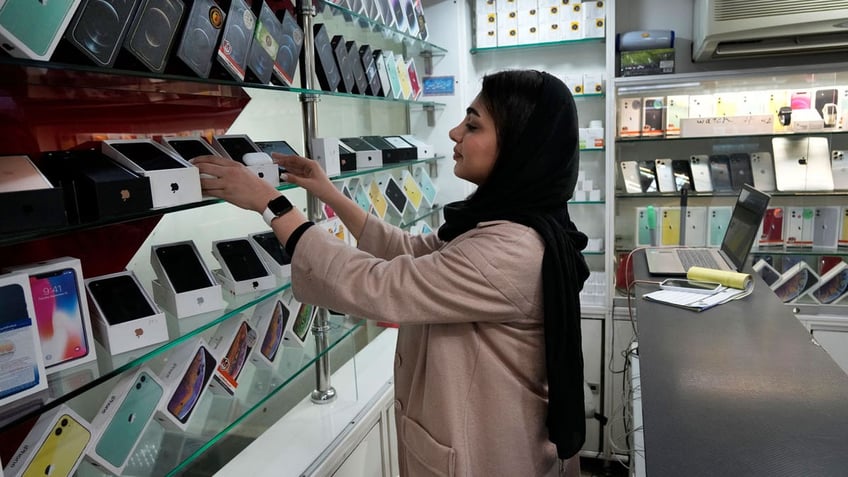 A cellphone vendor works at her shop