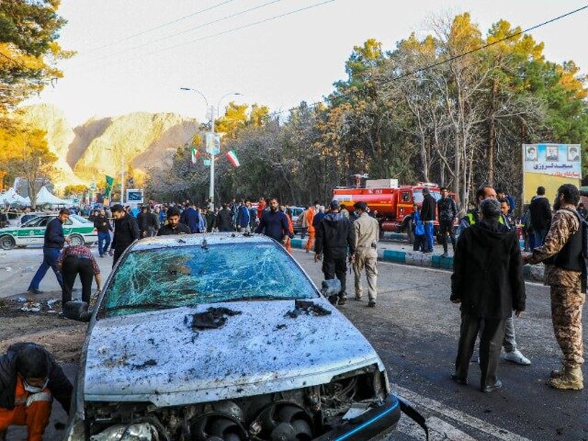 This picture shows people and Iranian emergency personnel at the site where two explosions in quick succession struck a crowd marking the anniversary of the 2020 killing of Guards general Qasem Soleimani, near the Saheb al-Zaman Mosque in the southern Iranian city of Kerman on January 3, 2024. Iran's president …