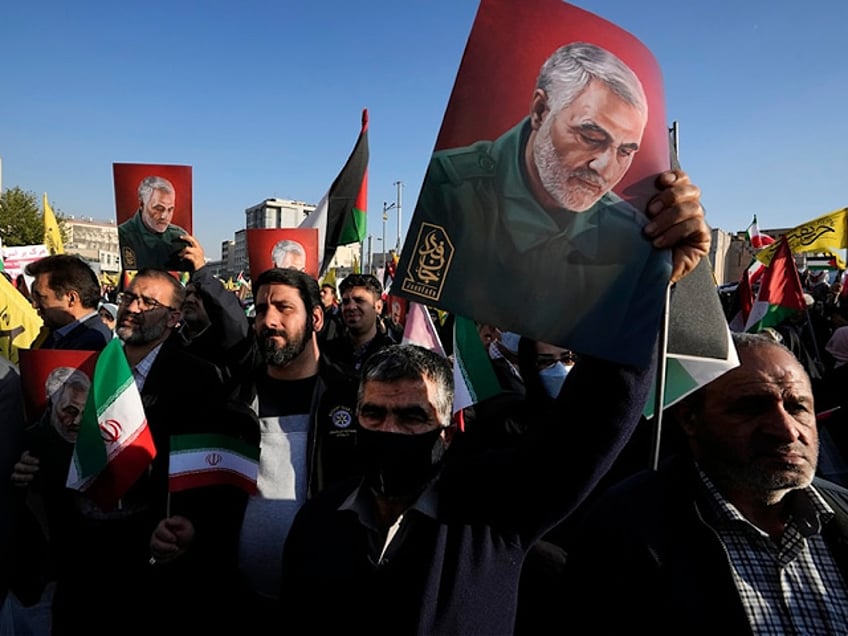 Iranian demonstrators hold posters of the late Revolutionary Guard Gen. Qassem Soleimani, who was killed in a U.S. drone attack in 2020, in a pro-Palestinian rally at Enqelab-e-Eslami (Islamic Revolution) Sq. in Tehran, Iran, Saturday, Nov. 18, 2023. (AP Photo/Vahid Salemi)