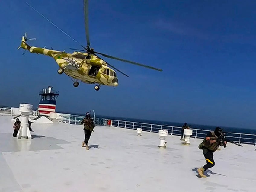 Iran - This photo released by the Houthi Media Center shows Houthi forces boarding the cargo ship Galaxy Leader on Sunday, Nov. 19, 2023. Yemen's Houthis have seized the ship in the Red Sea off the coast of Yemen after threatening to seize all vessels owned by Israeli companies. (Houthi Media Center via AP)