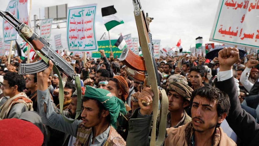 Houthis supporters waving guns in the air