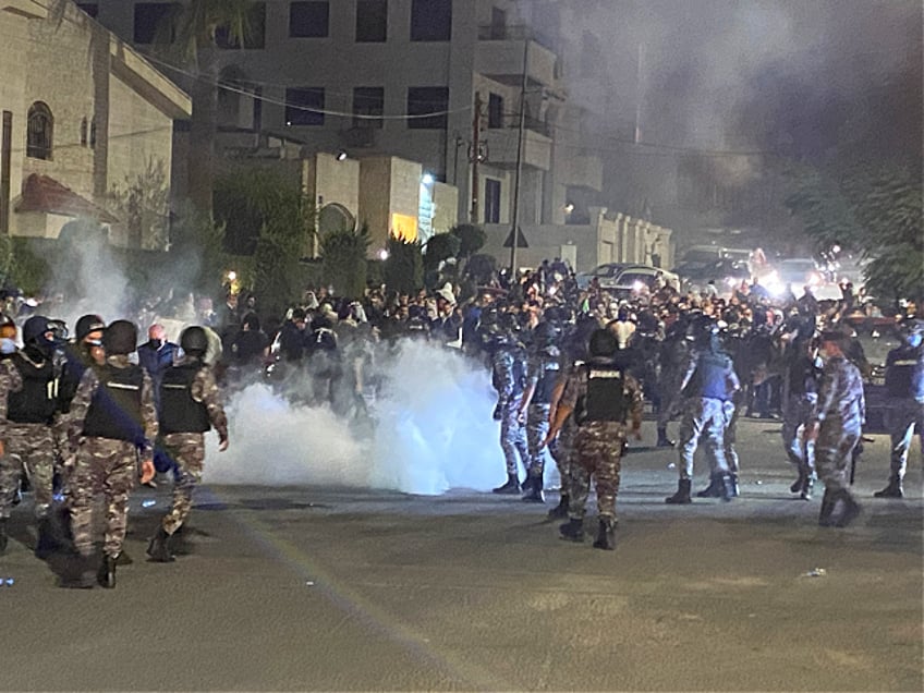 Jordanian security forces fire tear gas against demonstrators attempting to storm the Israeli embassy in the capital Amman, on October 17, 2023. Dozens of protesters attempted to storm the Israeli embassy compound in Amman, Jordan on October 17, after a strike on a hospital in the Gaza Strip killed at least 200 people, an AFP journalist said. (Photo by Mussa HATTAR / AFP) (Photo by MUSSA HATTAR/AFP via Getty Images)