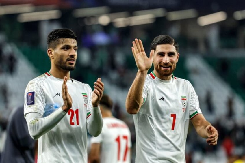 Iran's Mohammad Mohebi and (R) Alireza Jahanbakhsh celebrate in the group phase